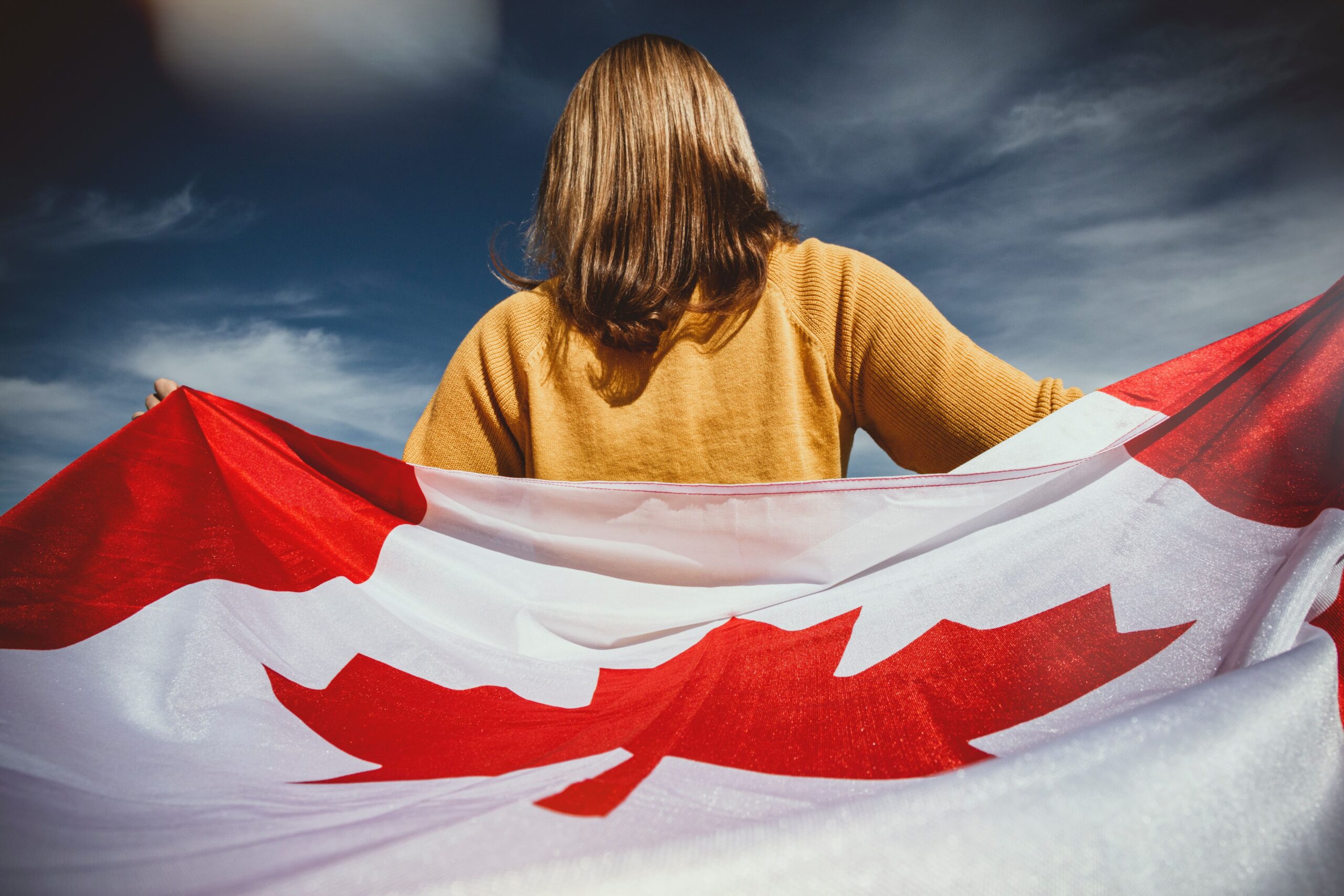 a woman holding the Canada flag