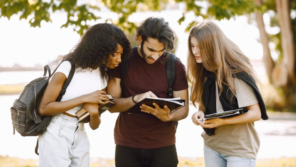 A group of students looking at a notebook