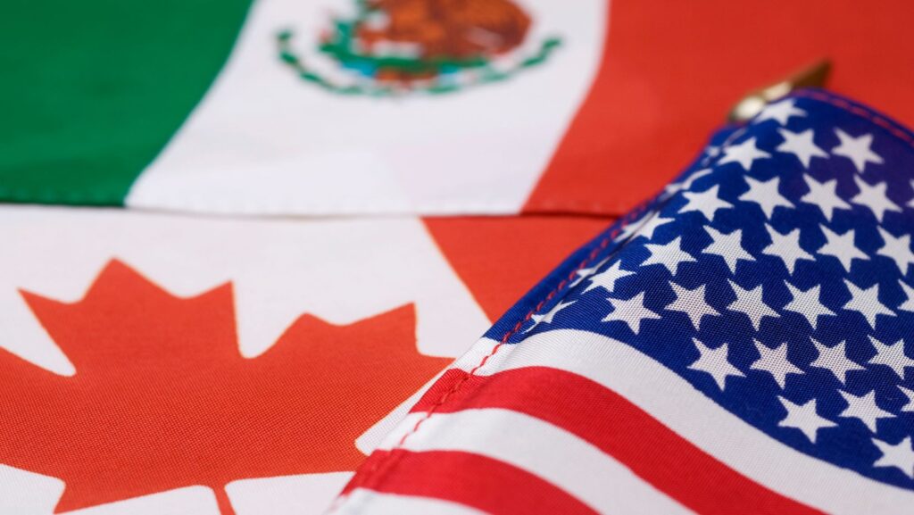 The flags of Mexico, the United States, and Canada.