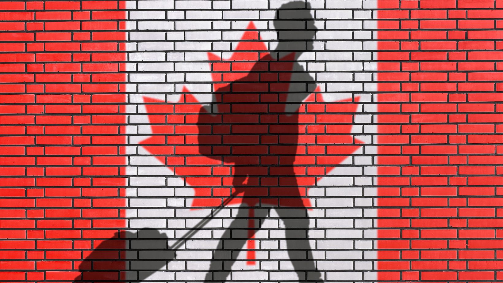 A persons shadow walking with a travel bag in front of a Canada flag
